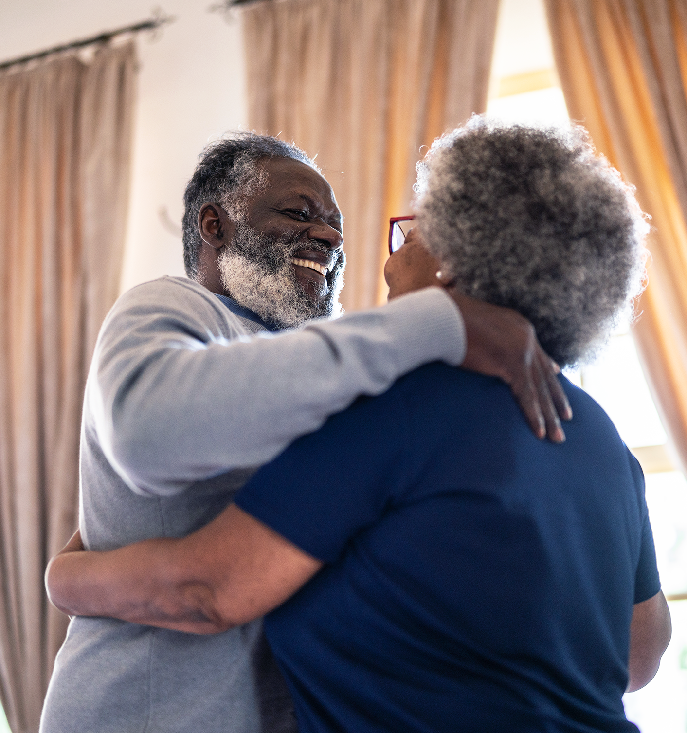 An older Black couple dancing.