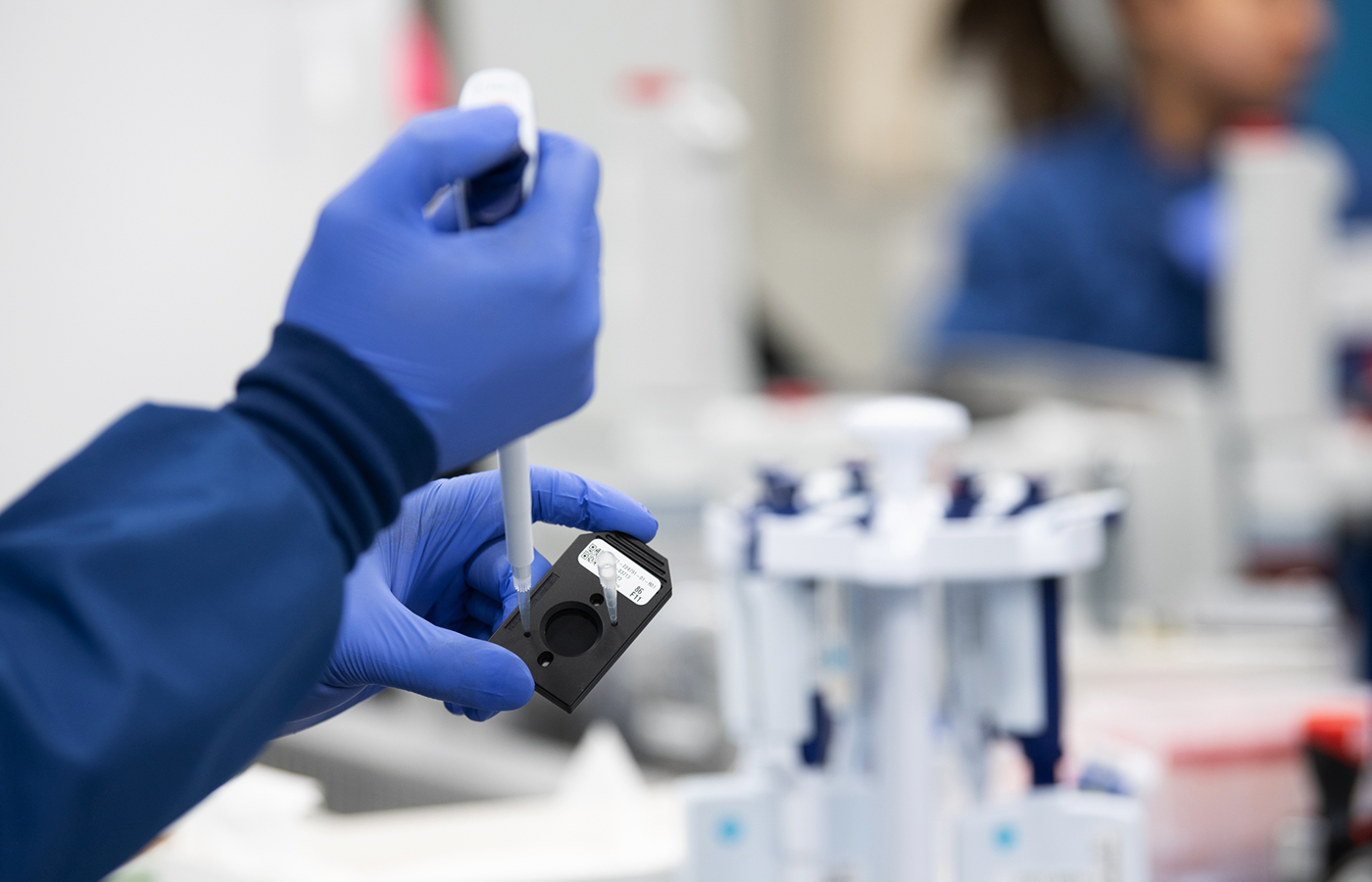 Lab employee works with a sample.